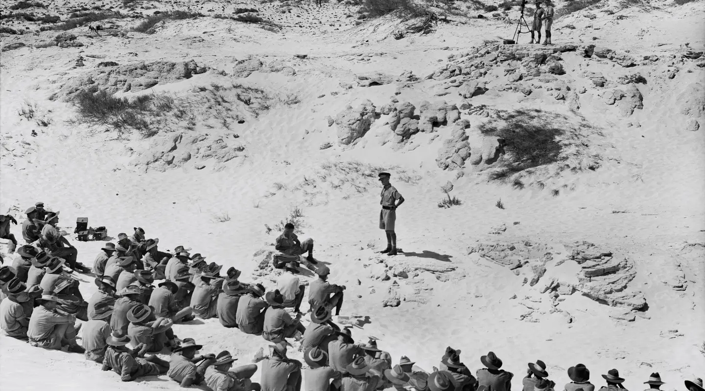 Servicemen sit among the sandhills of El Alamein for a church service in September 1942