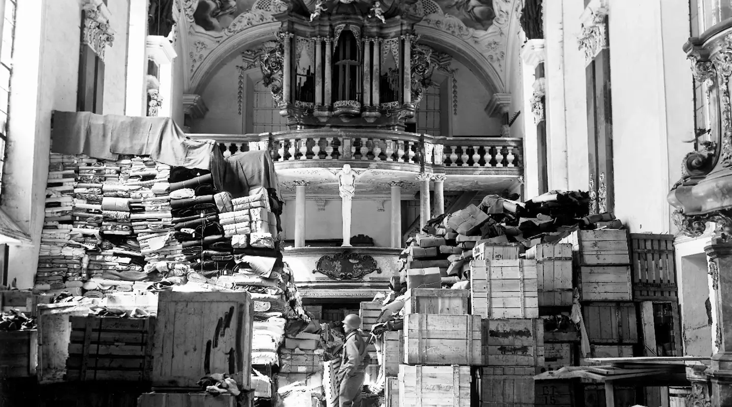 An American soldier inspects German loot, found at the Schlosskirche in the south German town Ellingen, 24 April 1945