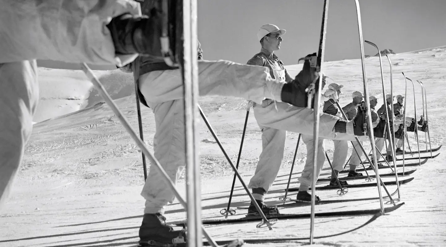 Members of the ski school line up to practice the kick turn.