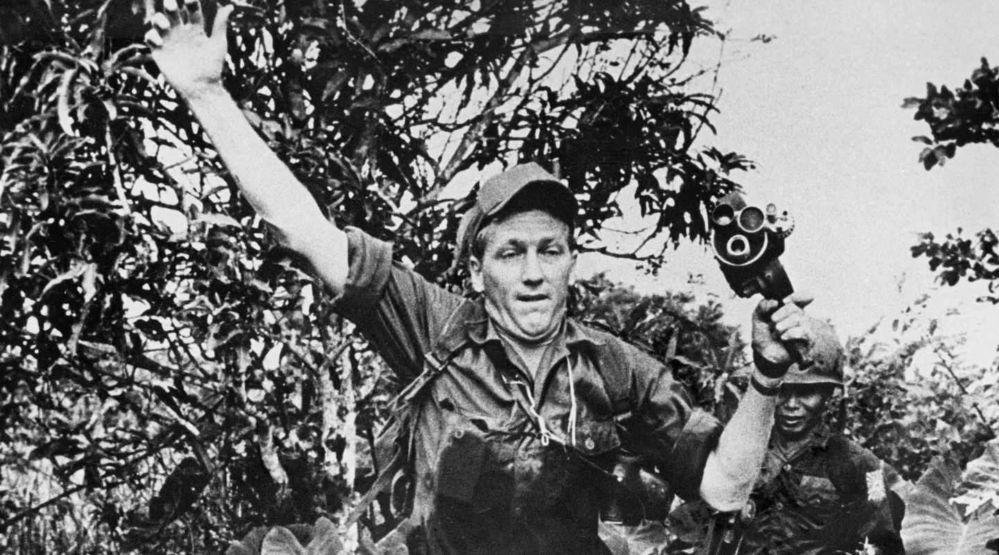 Neil Davis leaps through the jungles of South Vietnam with his hand held Bell and Howell camera c. 1967