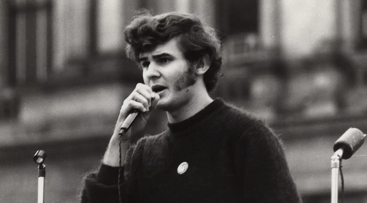 Lynn Arnold speaks into a microphone 