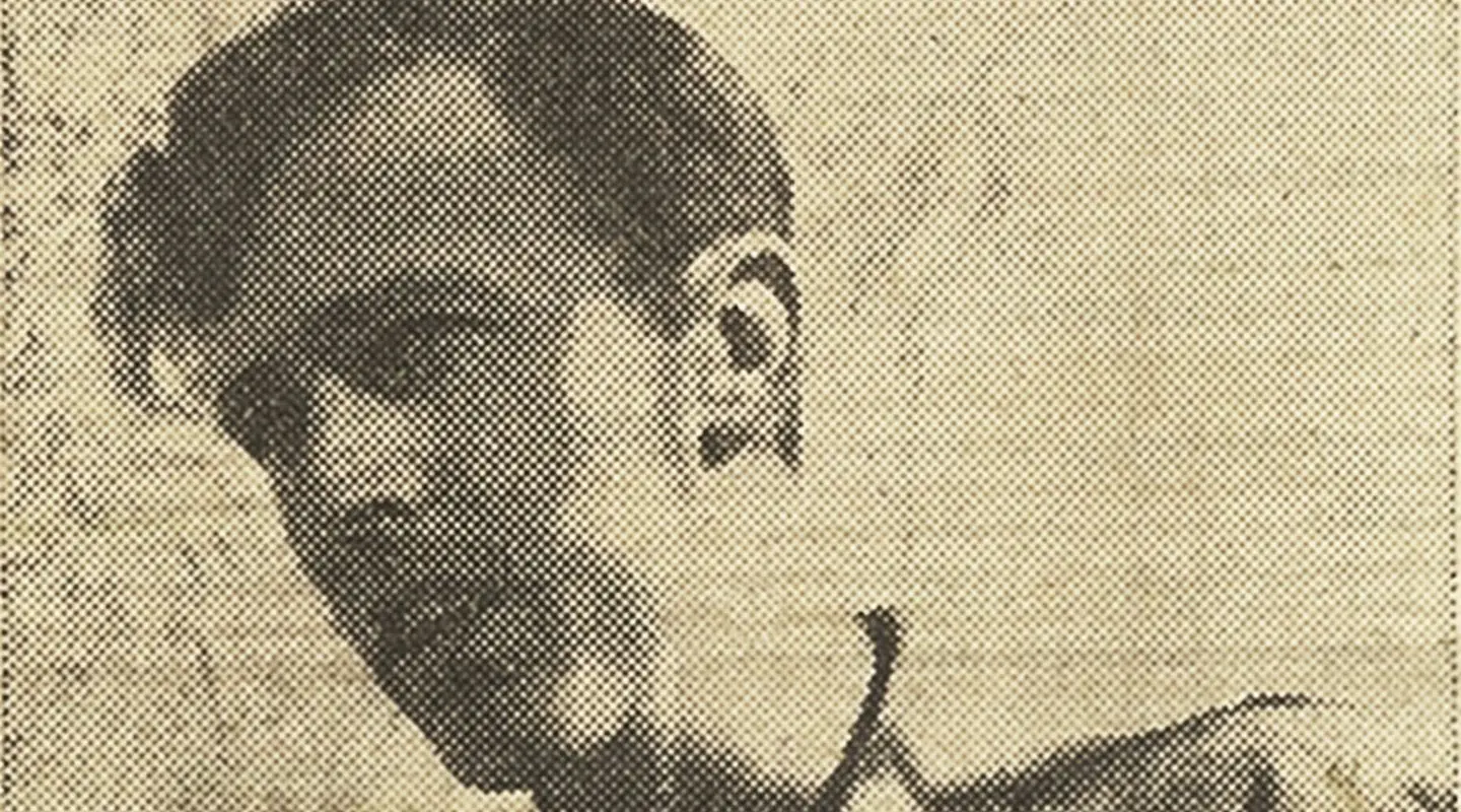 Chas Martin holds a microphone