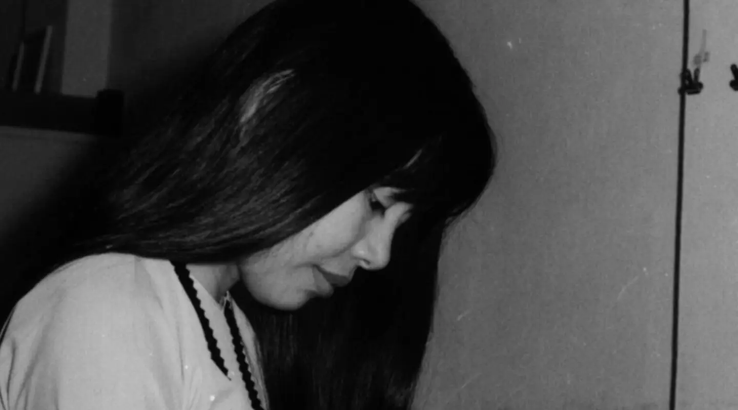 A young My-Van Tran reading a book