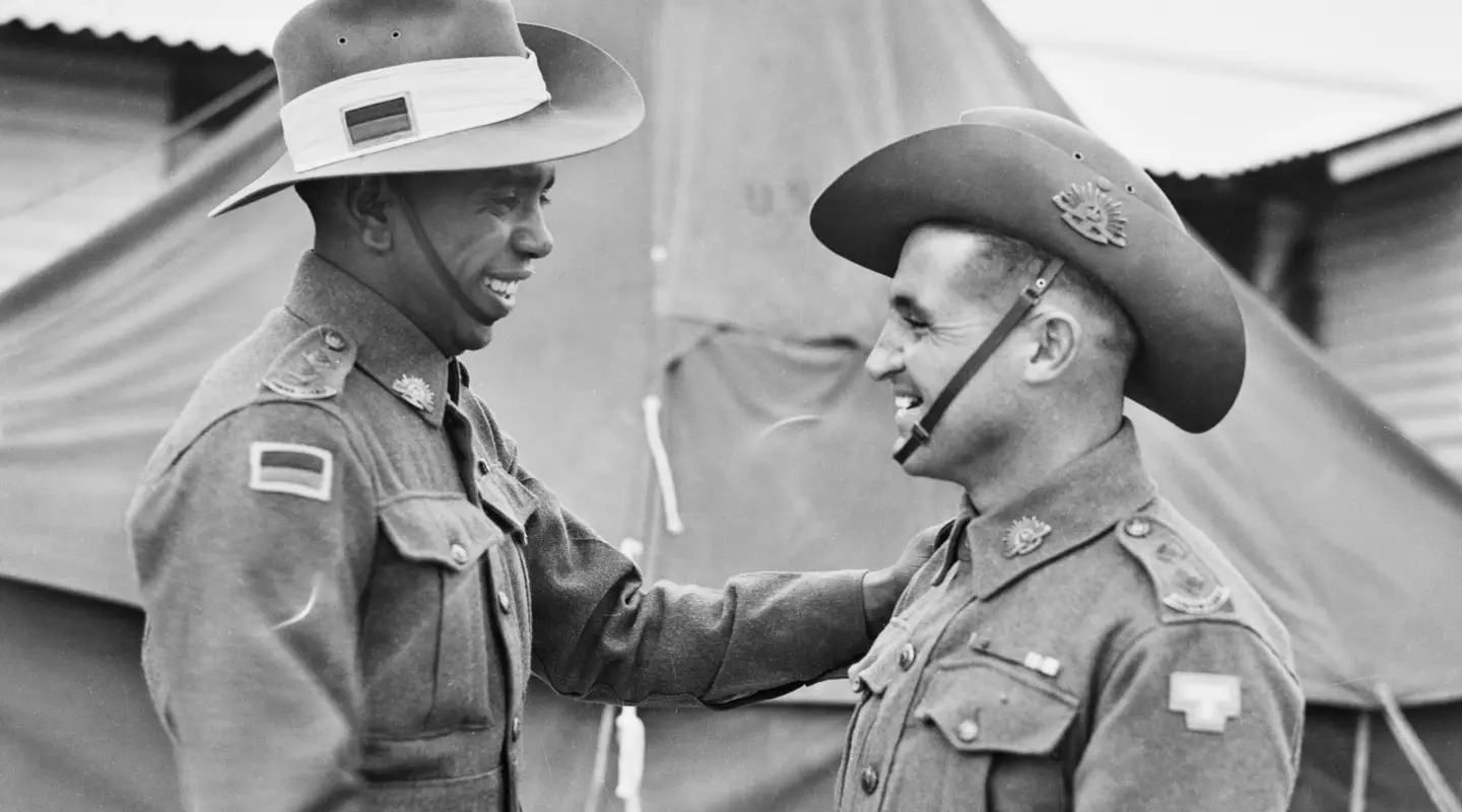  Reg Saunders and Tom Derrick shake hands after graduating from the Officer Cadets Training Unit