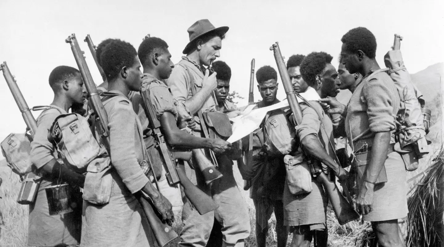 An Australian officer and a group of the 1st Papuan Infantry Battalion