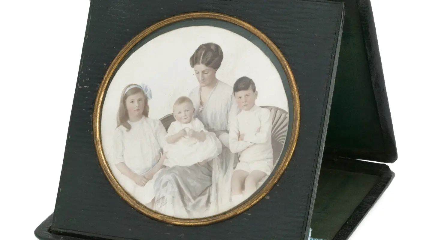 Black leather case contains a hand-coloured photograph of Lieutenant Colonel White's family.
