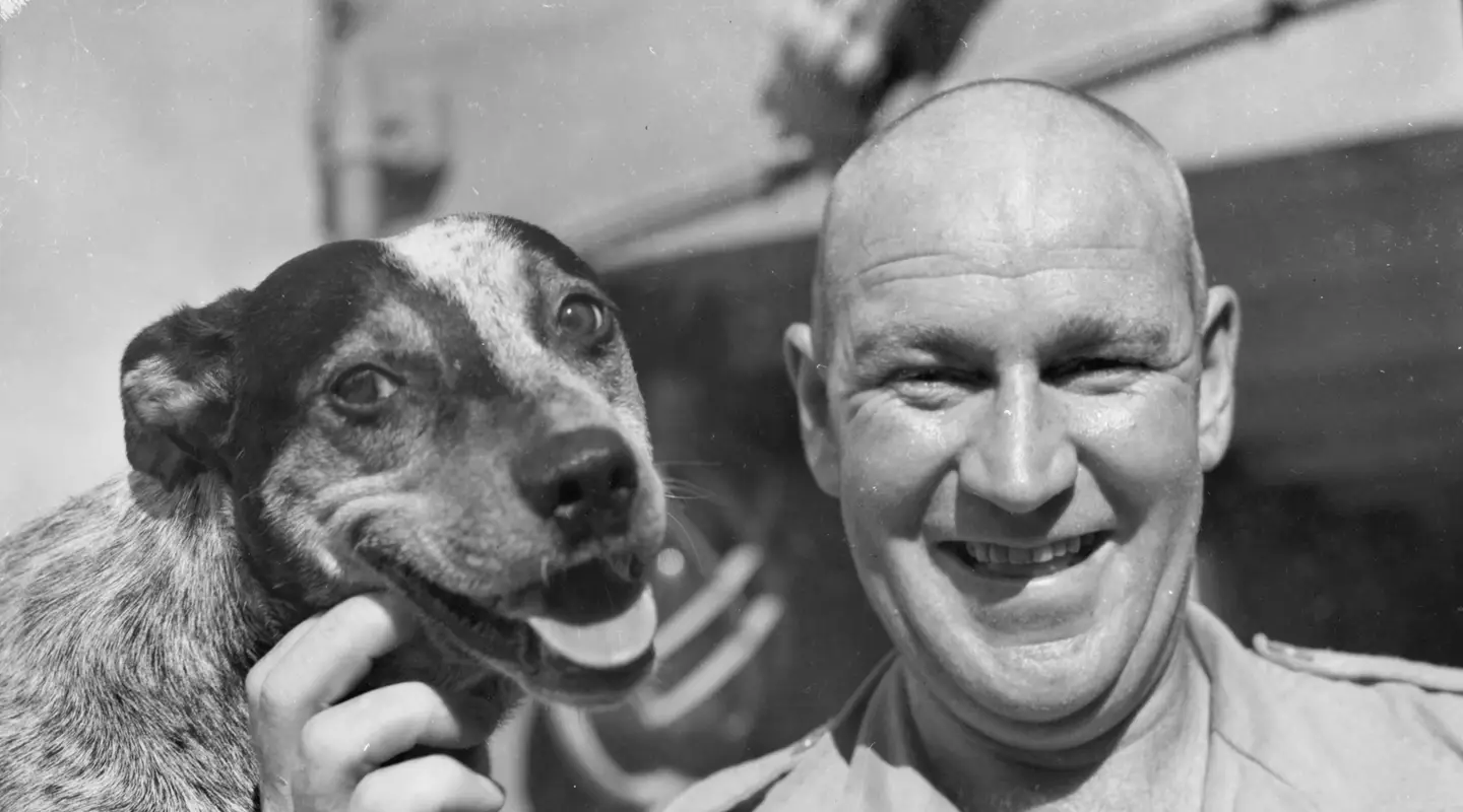 At sea from Fremantle - Pte George McCoullough 1st recovery section, 1st army field workshop with "Butch", the regimental dog that he and his pal Pte Archie Holmes brought from Sydney to Puckapunyal and then smuggled aboard.