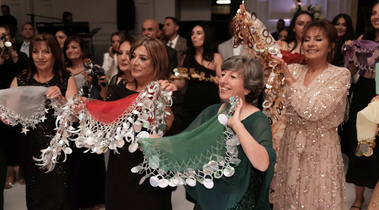 •	Dancers with yalekhtas at an Assyrian wedding in Australia. Photograph by Sitto Studios.