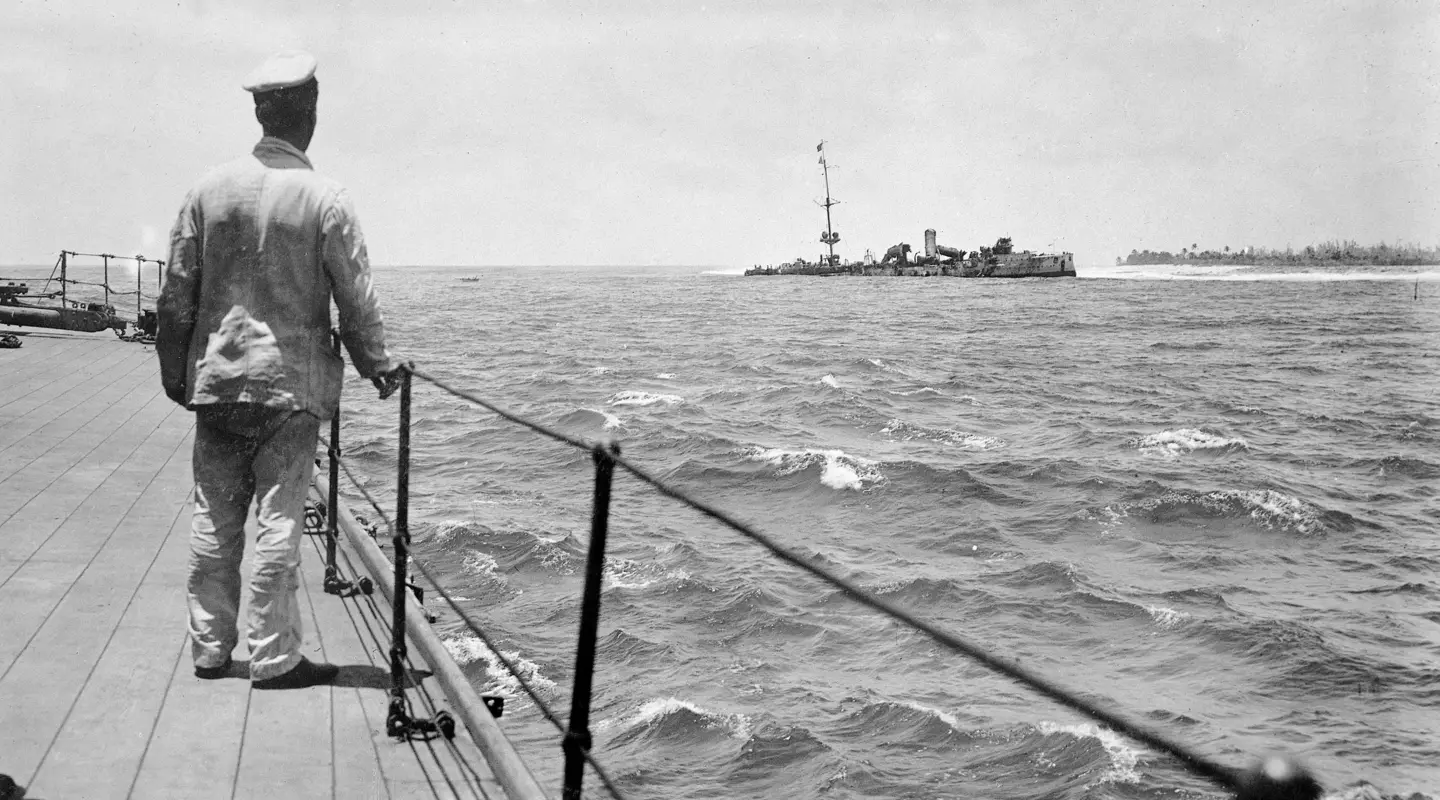 A sailor of HMAS Sydney looking at the wreck of SMS Emden, beached off North Keeling Island, November 1914