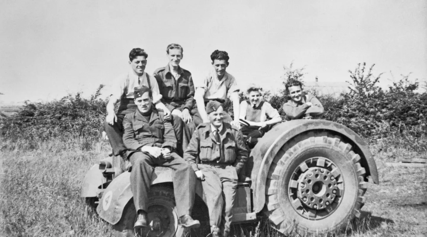 Ground maintenance crew of No. 463 Squadron RAAF posing on a RAF David Brown airfield tractor.