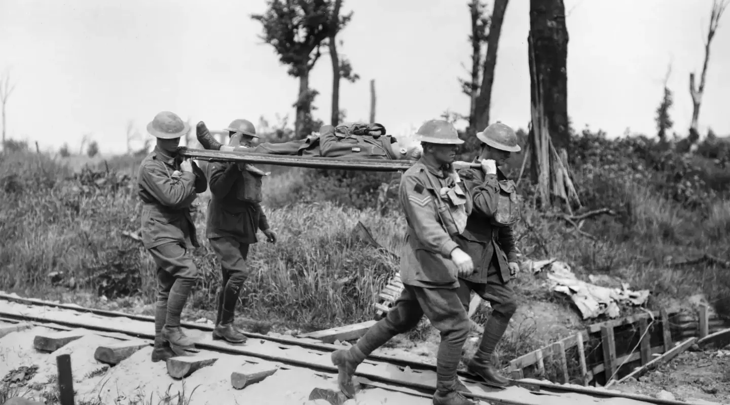 Four unidentified stretcher bearers of the 2nd Australian Division carrying a wounded soldier
