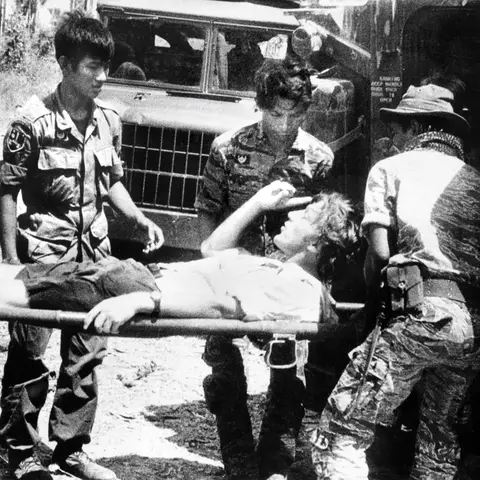 Davis on a stretcher after being injured by a mortar blast in Cambodia, 1974. 