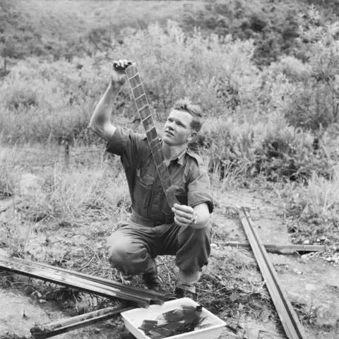 Private John ‘Dogger’ Dick examining his negatives