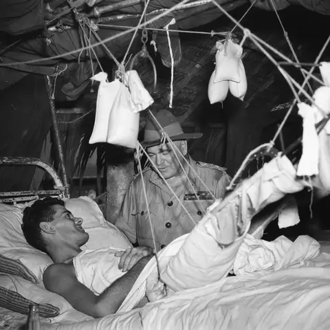 General Sir Thomas Blamey talks with Private H. J. Murphy at the 2/11th Australian General Hospital, New Guinea 1945