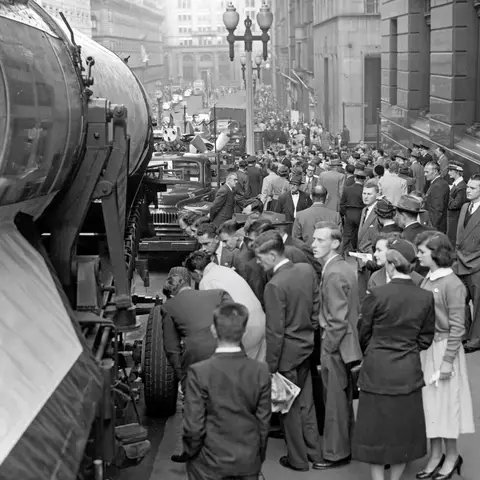 A V2 rocket, parked in Martin Place Sydney, as a crowd looks on.