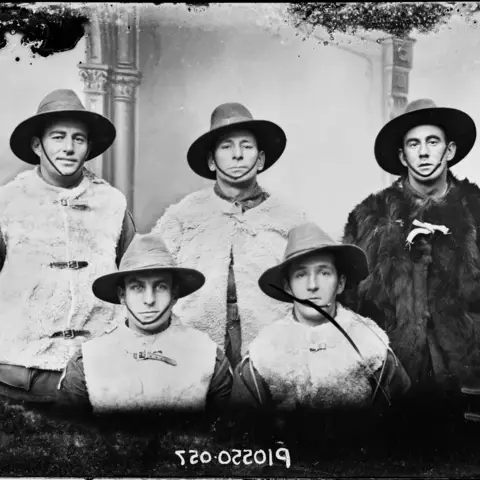 Five members of the 60th Battalion wearing sheepskin vests in France