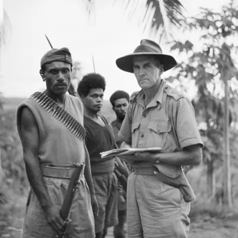 An Australian and PNG soldier prior to departure on patrol, New Guinea 1942