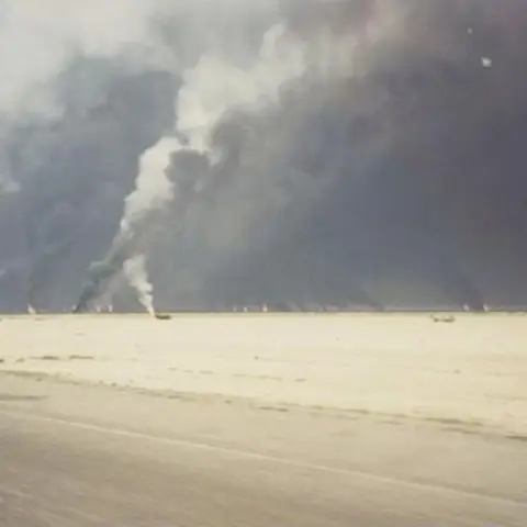 Smoke billowing out from burning oil wells. 