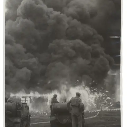 British soldiers burn the final remaining huts at the Bergen-Belsen concentration camp to avoid the spread of typhus. SUK14402