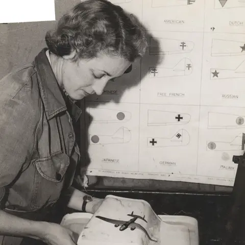 A member of the WAAAF develops photographic prints in a tray