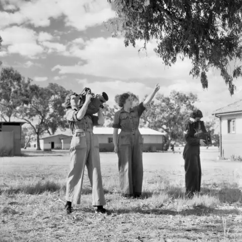 Testing an aerial camera after it has been overhauled in the workshop of No. 1 Operational Training Unit, RAAF.