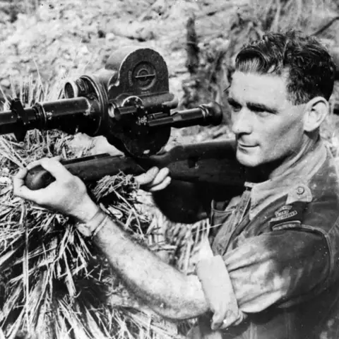 Roy Driver, using his Bell & Howell Eyemo cine camera with a telephoto lens in the Philippines.