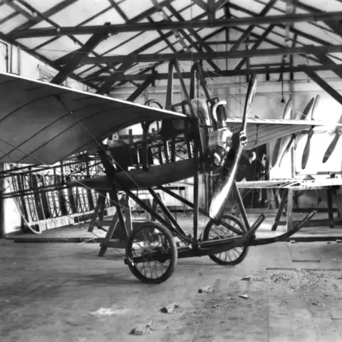 An aircraft assembly shop showing a Deperdussin aircraft in the foreground