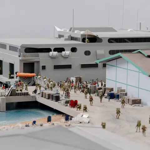 Close-up of Dili Diorama detail – Australian troops disembark HMAS Jervis Bay carrying water ration boxes.