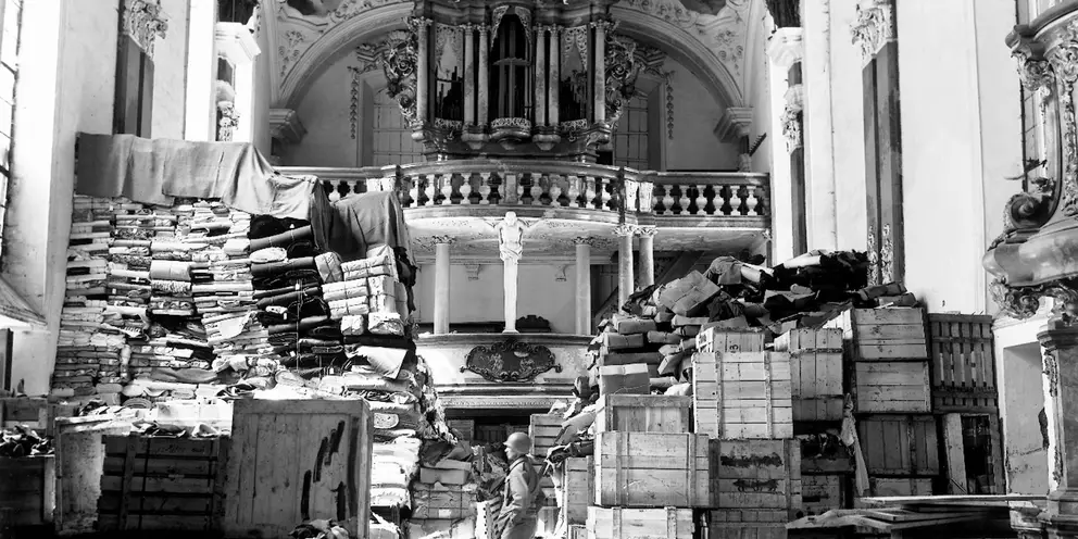 An American soldier inspects German loot, found at the Schlosskirche in the south German town Ellingen, 24 April 1945