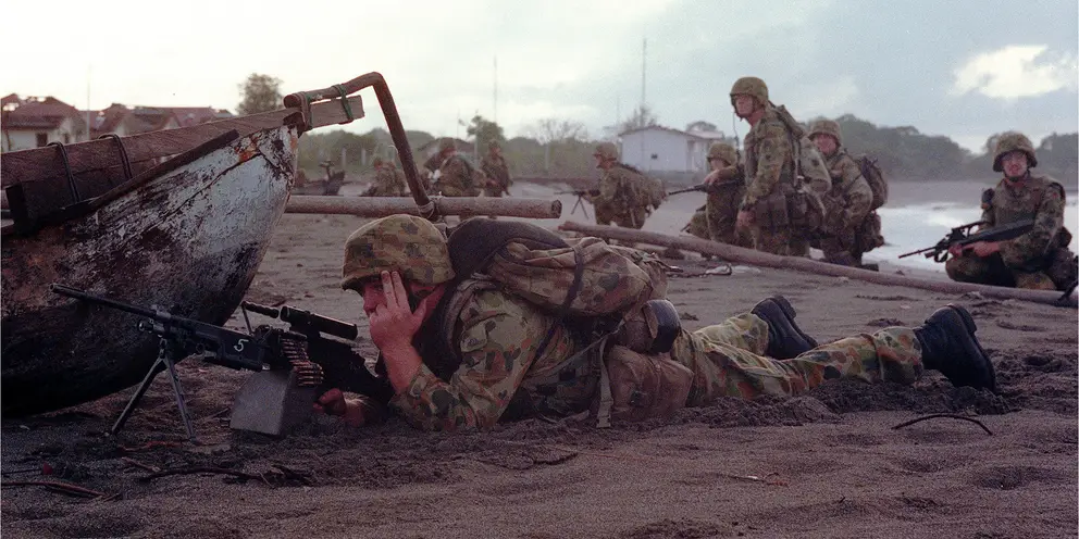 Australian troops take up position on the Suai shoreline during Operation Laverack