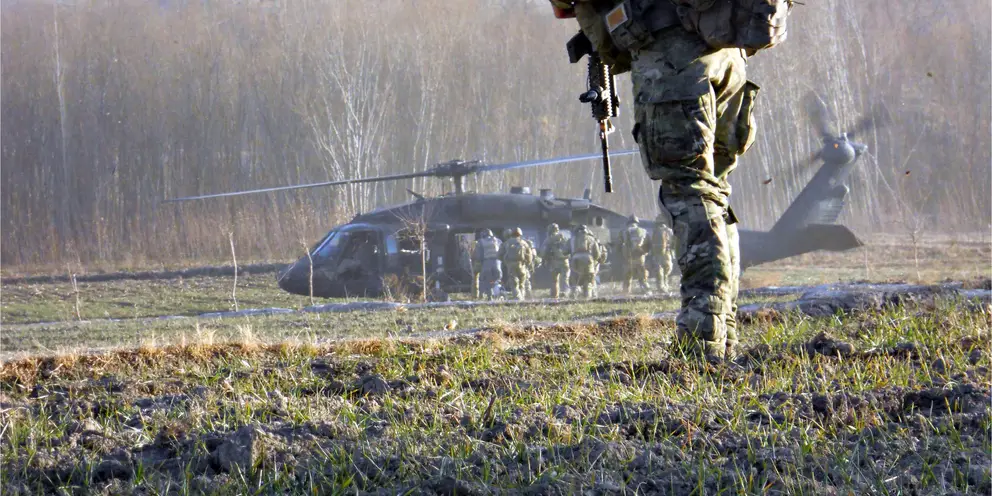 A Special Forces Reservist watches his colleagues enter a Blackhawk in Uruzgan.
