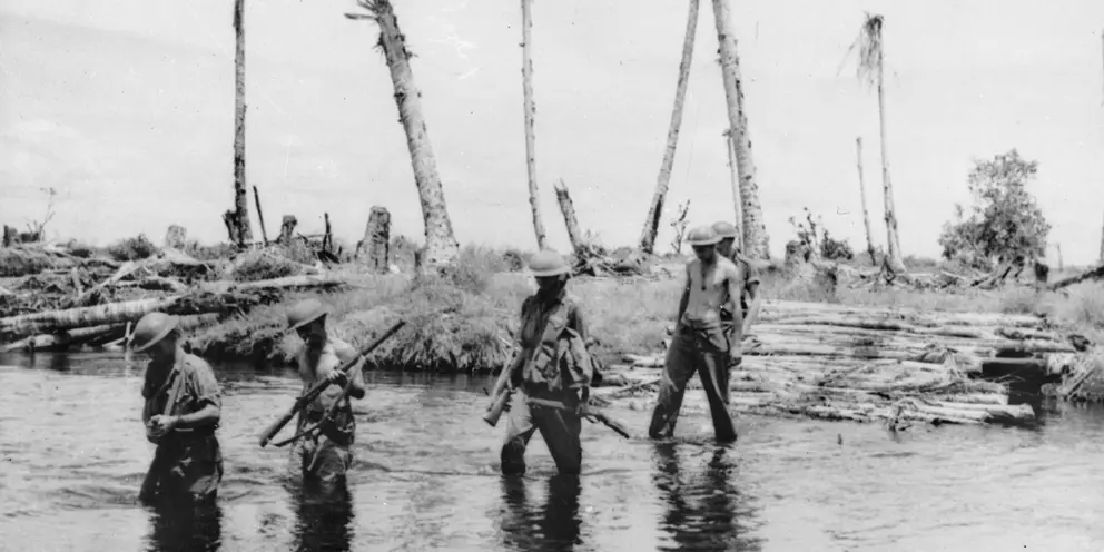  Australians cross a creek at Sanananda,  Papua, 27 January 1943. AWM014243