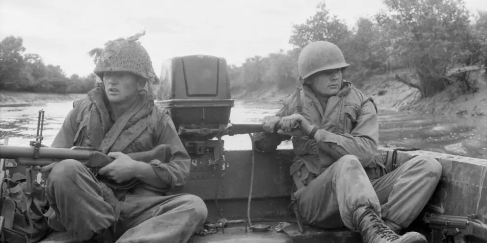 Sapper Darryl Lavis  (left) and Sapper  Edward Podlich  at the tiller of the  assault raft.
