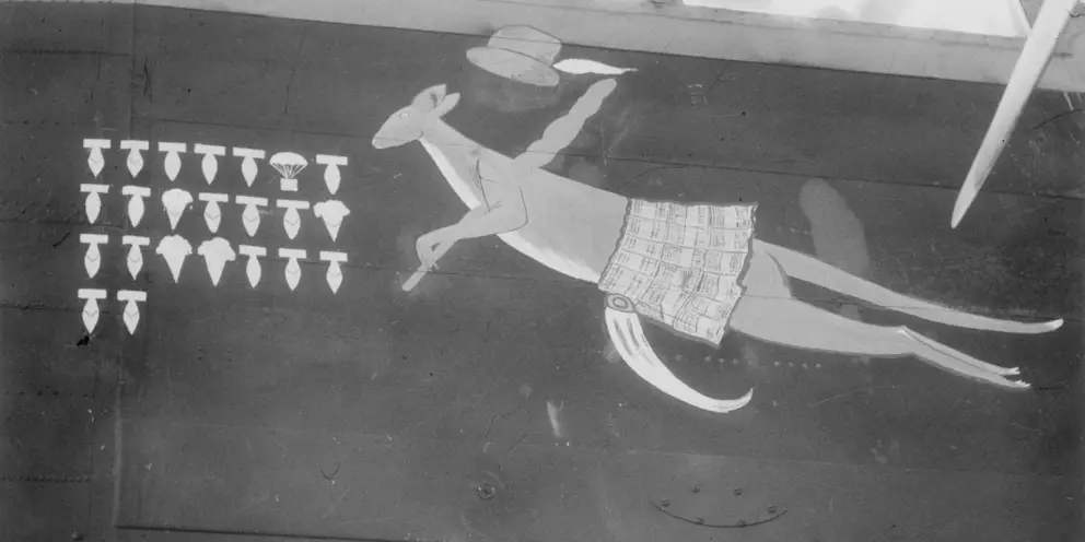 LINCOLNSHIRE, ENGLAND. 1943-09-08. "N" FOR NUTS, A LANCASTER AIRCRAFT OF NO. 460 SQUADRON RAAF OF BOMBER COMMAND, BASED AT RAF STATION BINBROOK, BEARS AS ITS EMBLEM A KANGAROO WEARING A TARTAN KILT AND CARRYING A SHILLELAGH, REPRESENTING THE AUSTRALIAN, SCOTTISH AND IRISH MEMBERS OF THE CREW. THE BOMBS DEPICT RAIDS ON ENEMY TERRITORY, THE ICE CREAM CONES SHOWING ITALIAN TARGETS, AND THE PARACHUTE REPRESENTS MINE-LAYING IN ENEMY WATERS. AWM UK0504