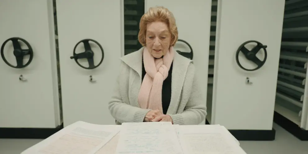 Rae Maree Curtis sits surrounded by an array of letters.