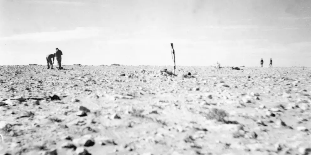  Members  of the 2/28th  Australian Infantry Battalion searching for missing men after the attack.  AWM 042488