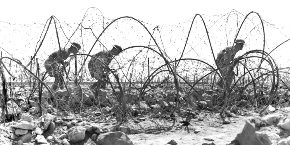 Australian troops pass through the perimeter on a patrol in the Tobruk area.