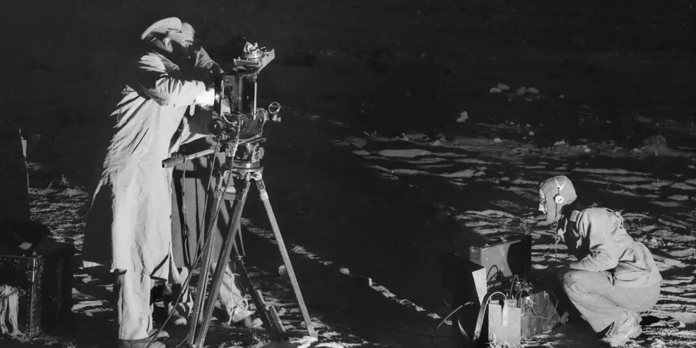 Frank Hurley at the camera while Alan Anderson records the sound of distant bombardment 1941