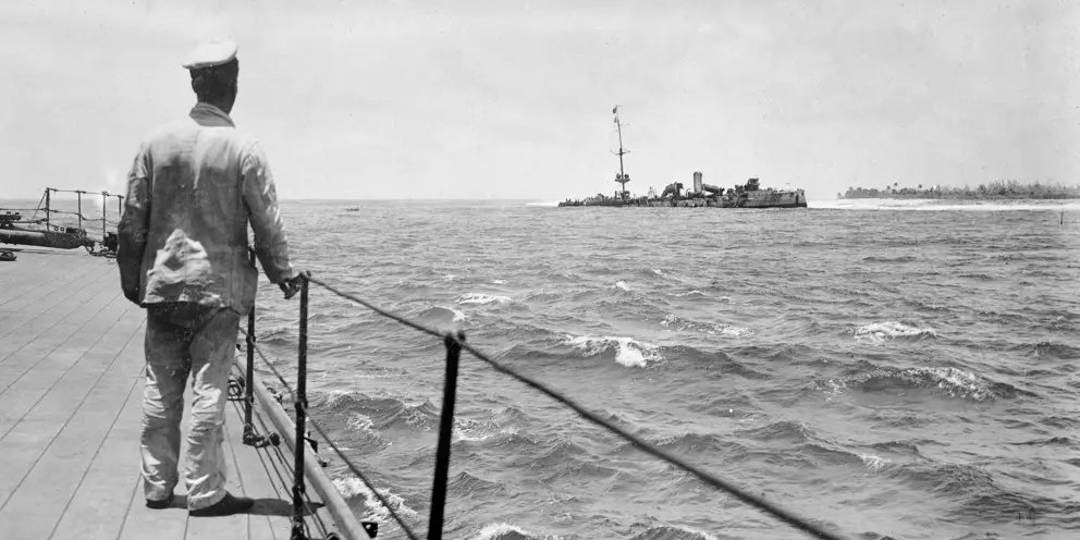 A sailor of HMAS Sydney looking at the wreck of SMS Emden, beached off North Keeling Island, November 1914
