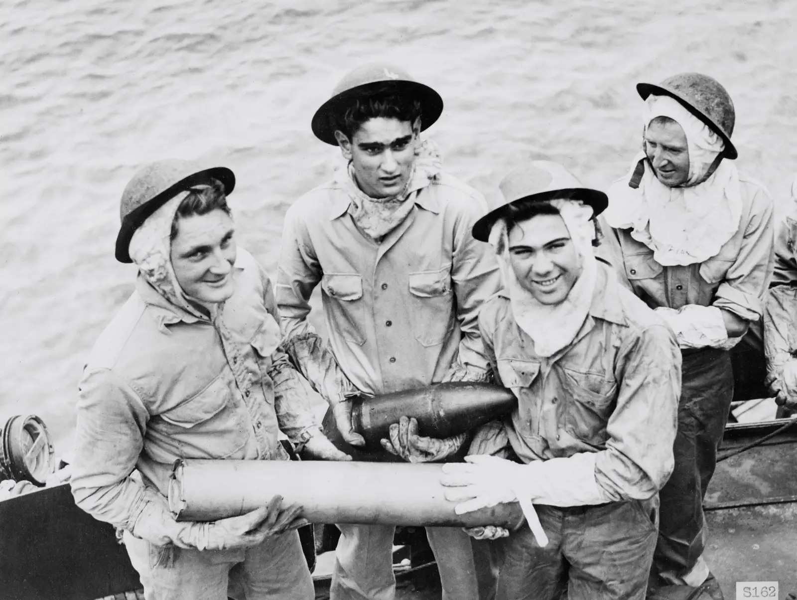Four men from an Australian destroyer gun crew in action. December 1943.