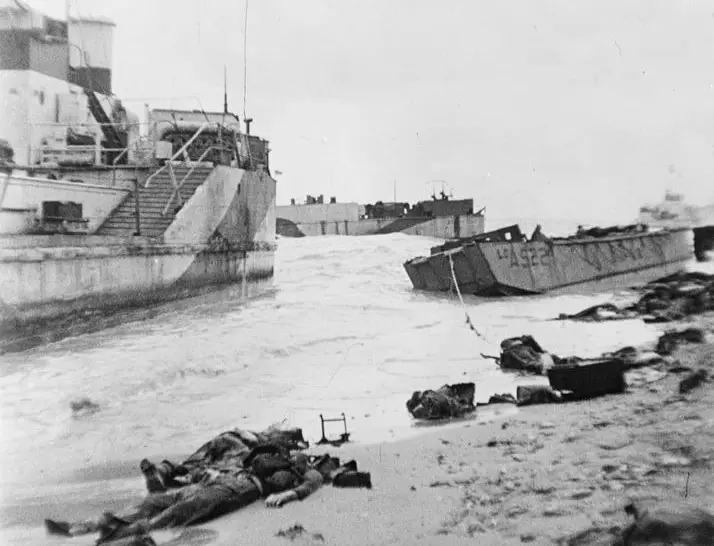 Bodies and beached landing craft litter Juno Beach on D-Day. IWM MH 2329