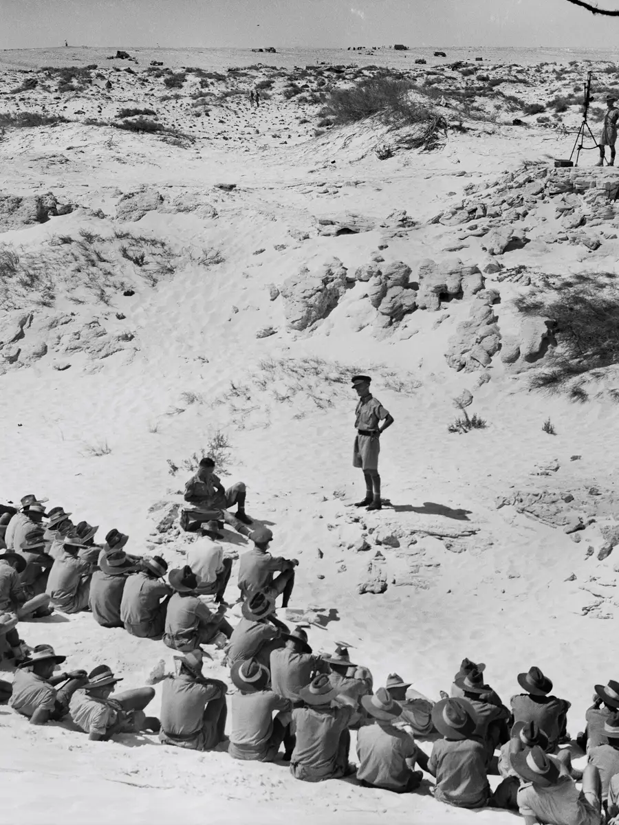 Servicemen sit among the sandhills of El Alamein for a church service in September 1942
