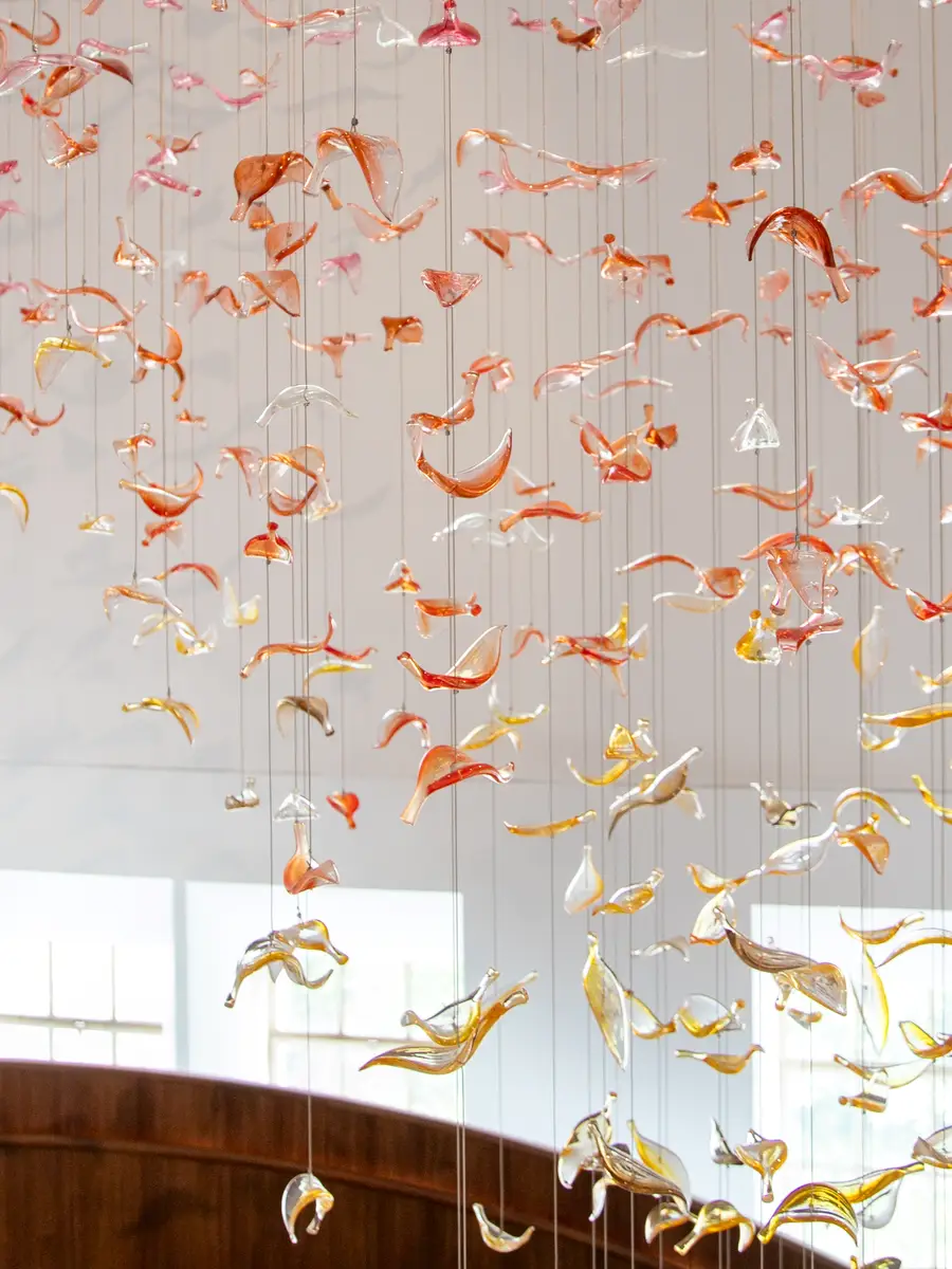 Glass leaves suspended in the stairwell