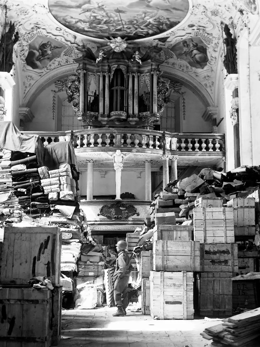 An American soldier inspects German loot, found at the Schlosskirche in the south German town Ellingen, 24 April 1945