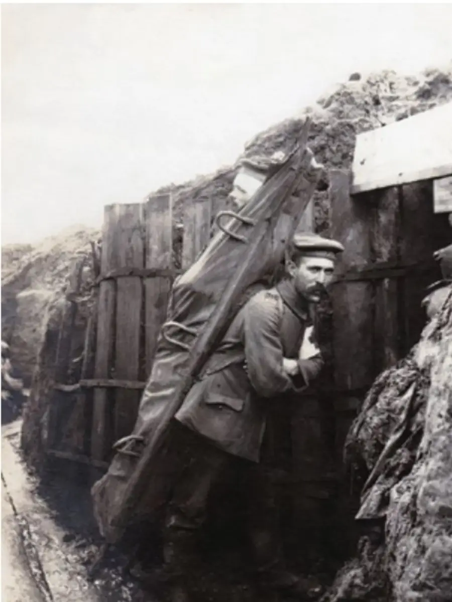 A German stretcher bearer carrying a patient to an Aid Post. 