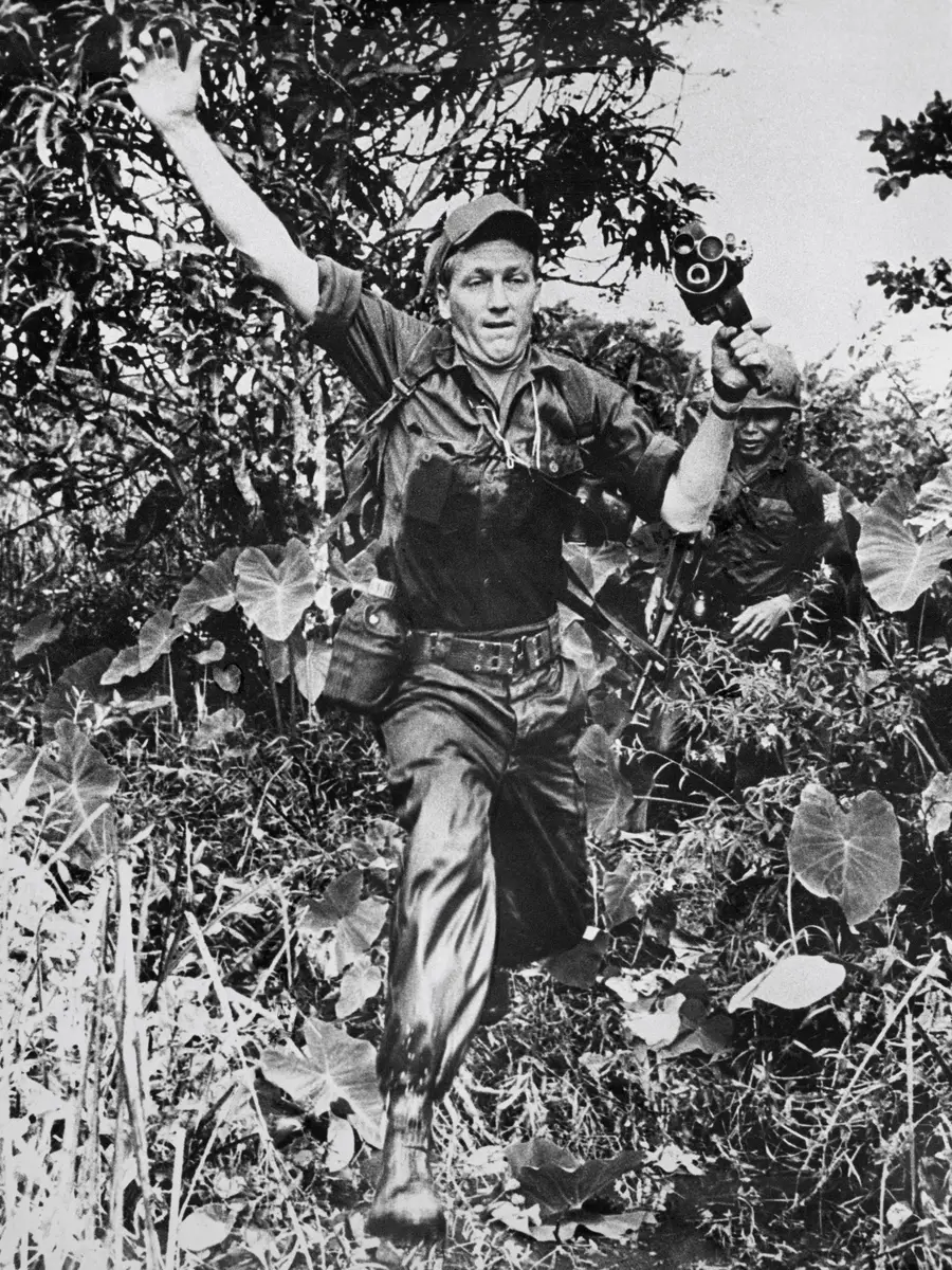 Neil Davis leaps through the jungles of South Vietnam with his hand held Bell and Howell camera c. 1967
