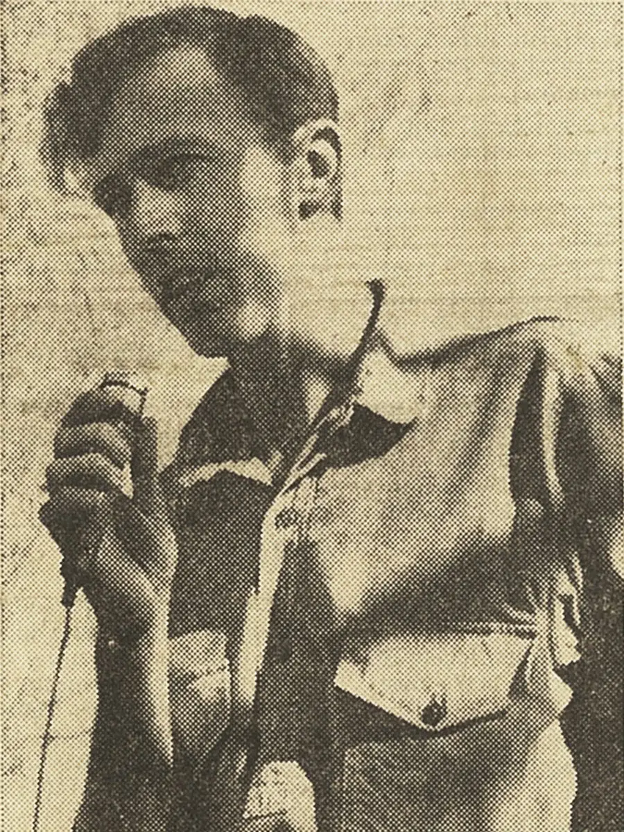 Chas Martin holds a microphone