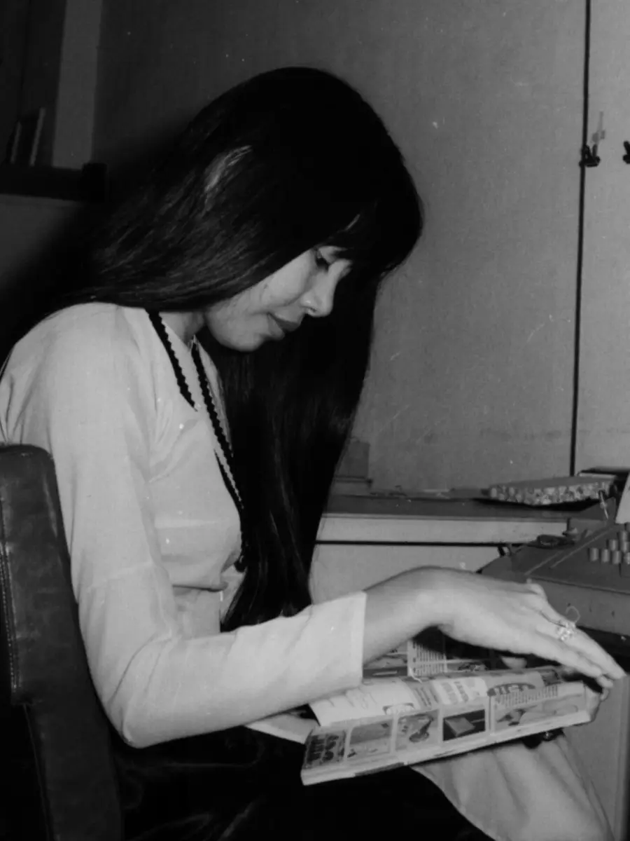 A young My-Van Tran reading a book