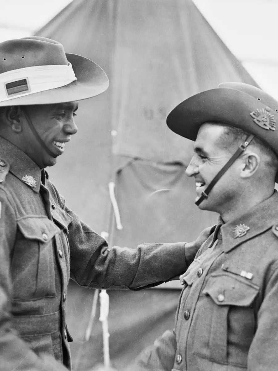 Reg Saunders and Tom Derrick shake hands after graduating from the Officer Cadets Training Unit