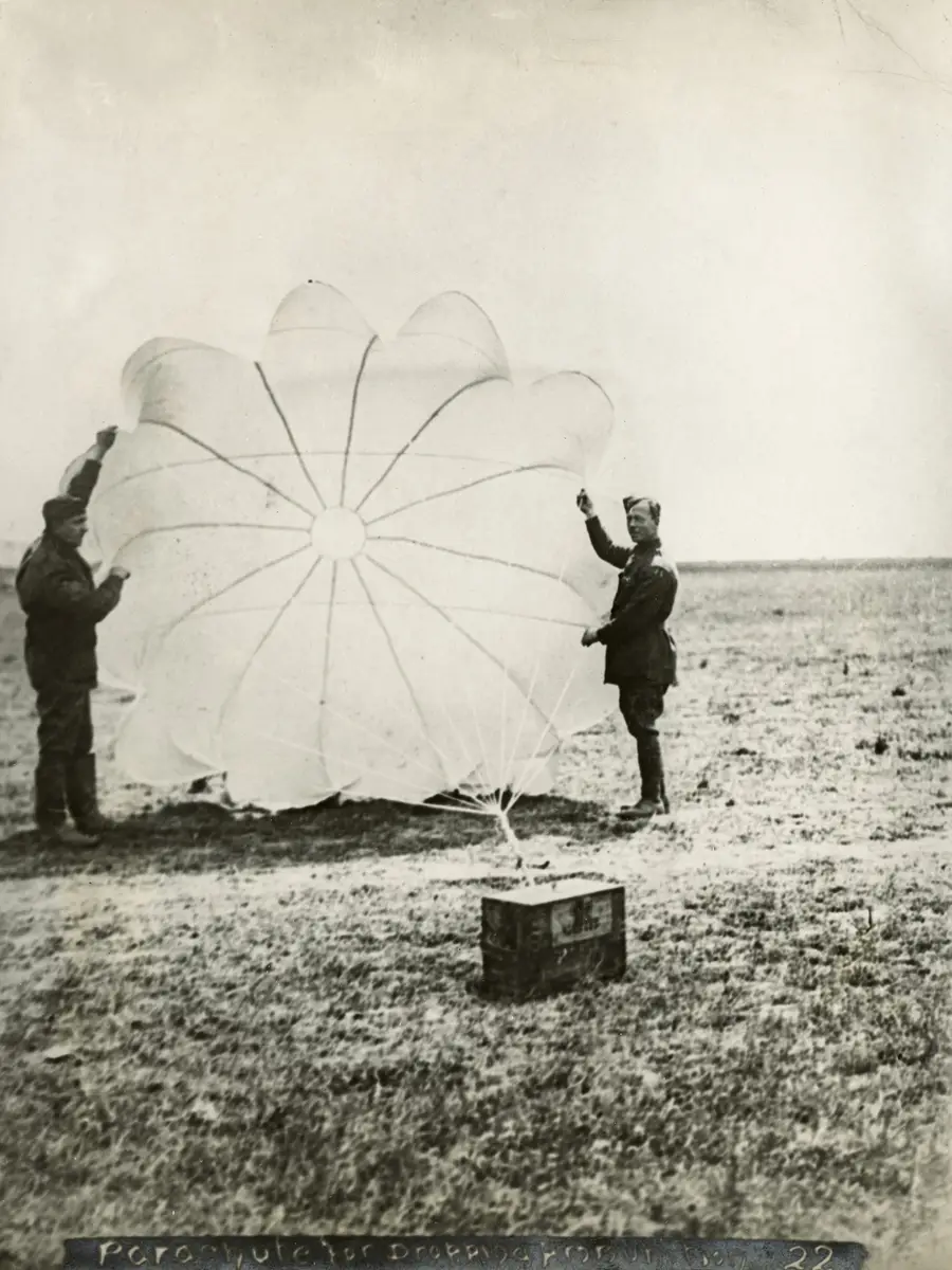 Members of No. 3 Squadron with one of the parachutes for dropping ammunition. 